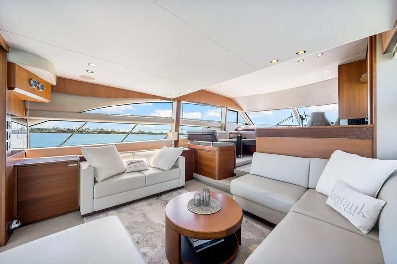  Yacht Photos Pics Luxurious interior of 2017 Princess 56 yacht with elegant seating and panoramic windows.
