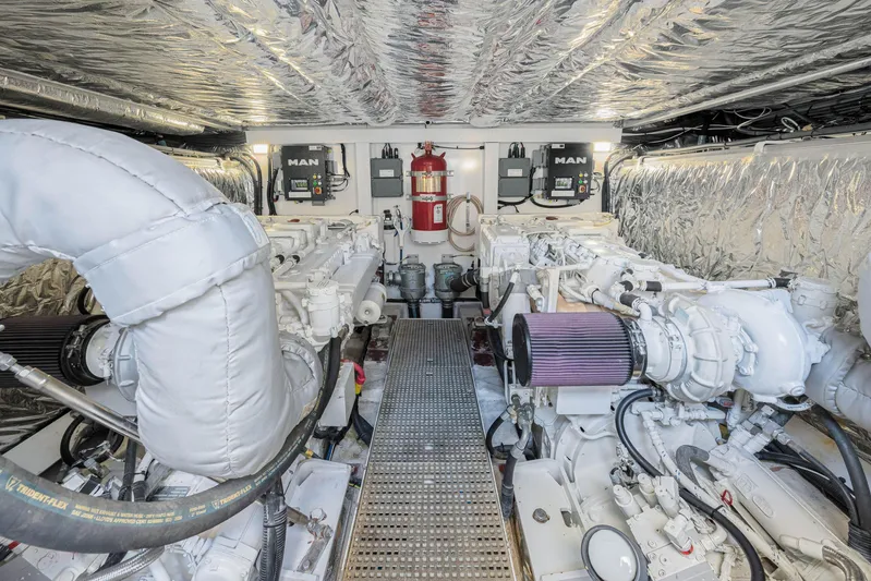  Yacht Photos Pics Engine room of a 2017 Princess 56 yacht, featuring dual MAN engines and fire safety equipment.