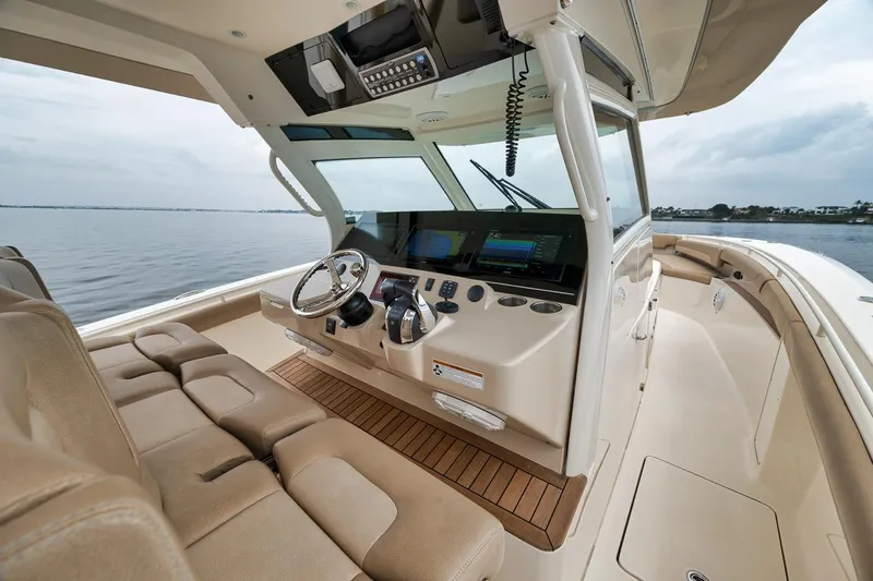 Pain Killer Yacht Photos Pics 2018 Scout 380LXF boat interior with modern helm and seating, overlooking calm waters.