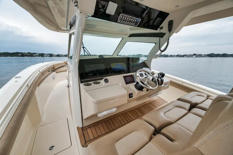 Pain Killer Yacht Photos Pics 2018 Scout 380LXF boat interior with modern helm, leather seating, and ocean view.