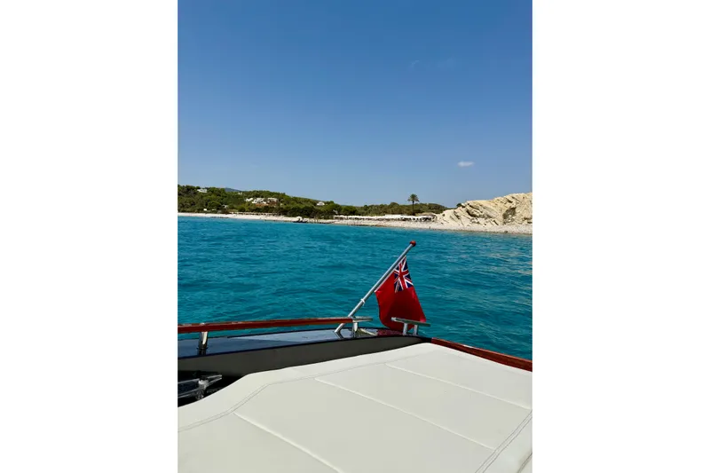  Yacht Photos Pics 2025 Riva Rivamare yacht cruising near a scenic coastline with clear blue waters.