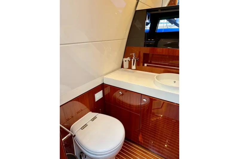  Yacht Photos Pics Luxurious 2025 Riva Rivamare yacht bathroom with sleek wood finishes and modern fixtures.