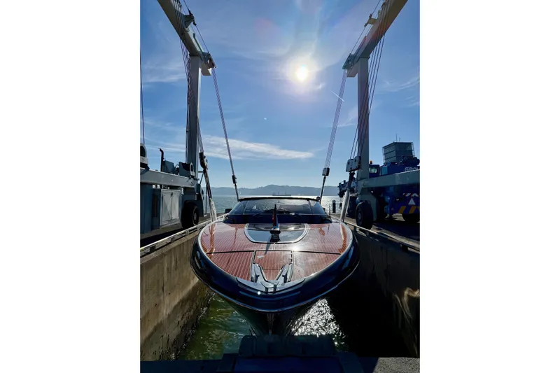  Yacht Photos Pics 2025 Riva Rivamare yacht in dry dock under bright sun, showcasing sleek design.