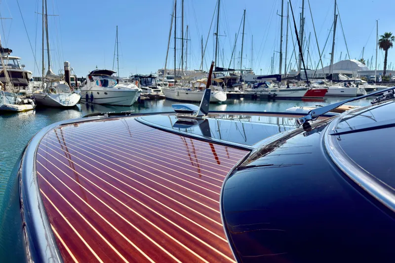  Yacht Photos Pics 2025 Riva Rivamare yacht with sleek wooden deck in a marina setting.