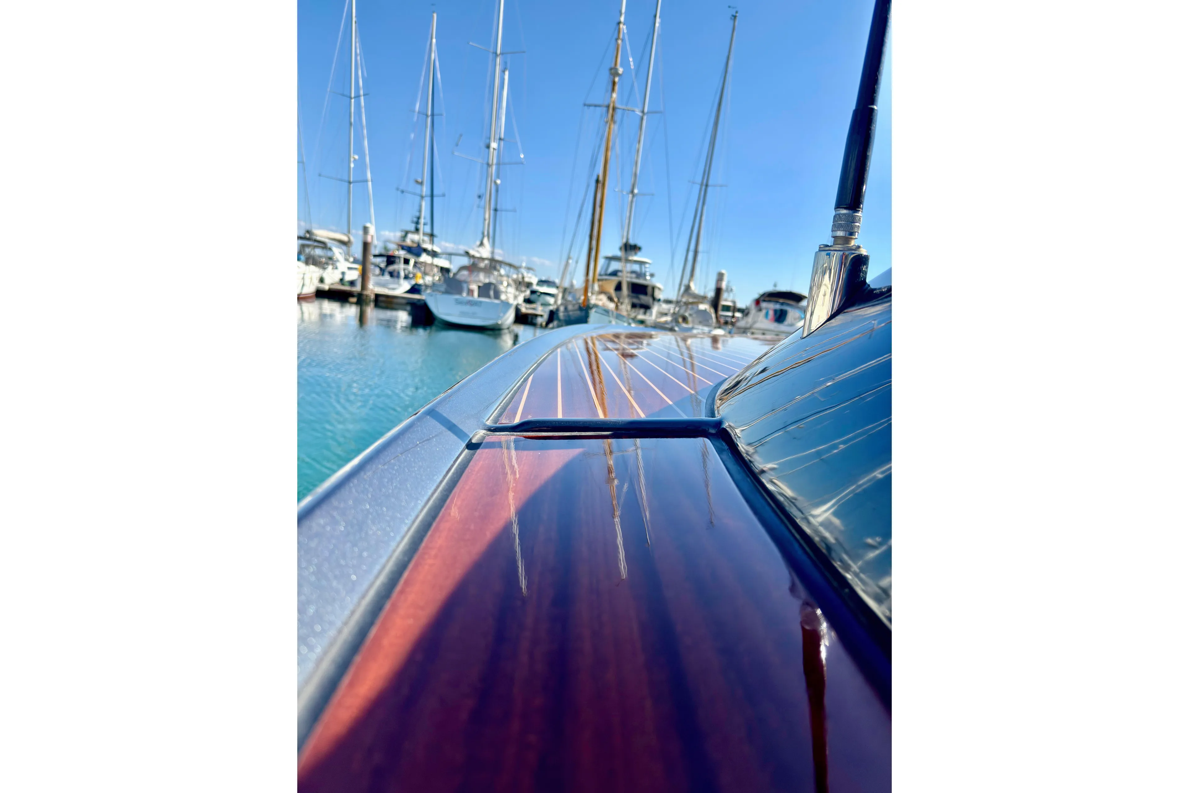  Yacht Photos Pics 2025 Riva Rivamare yacht with sleek wooden deck, docked in a marina.