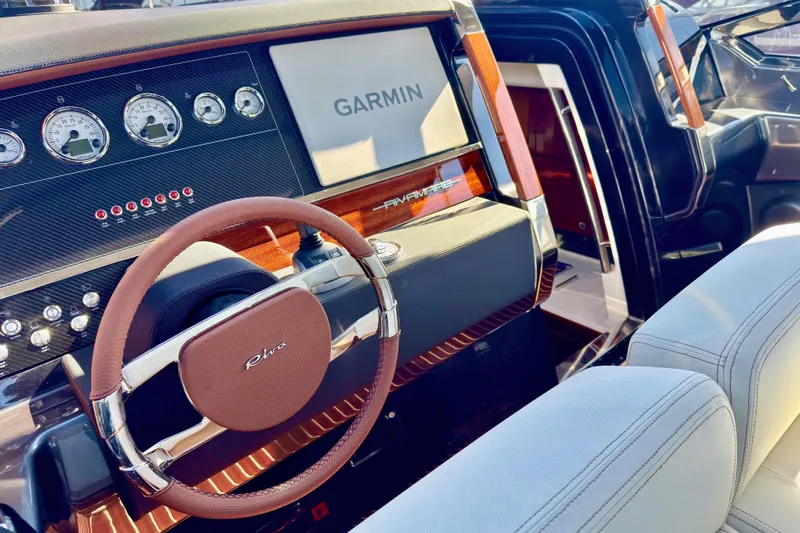  Yacht Photos Pics 2025 Riva Rivamare dashboard with Garmin display and elegant steering wheel design.