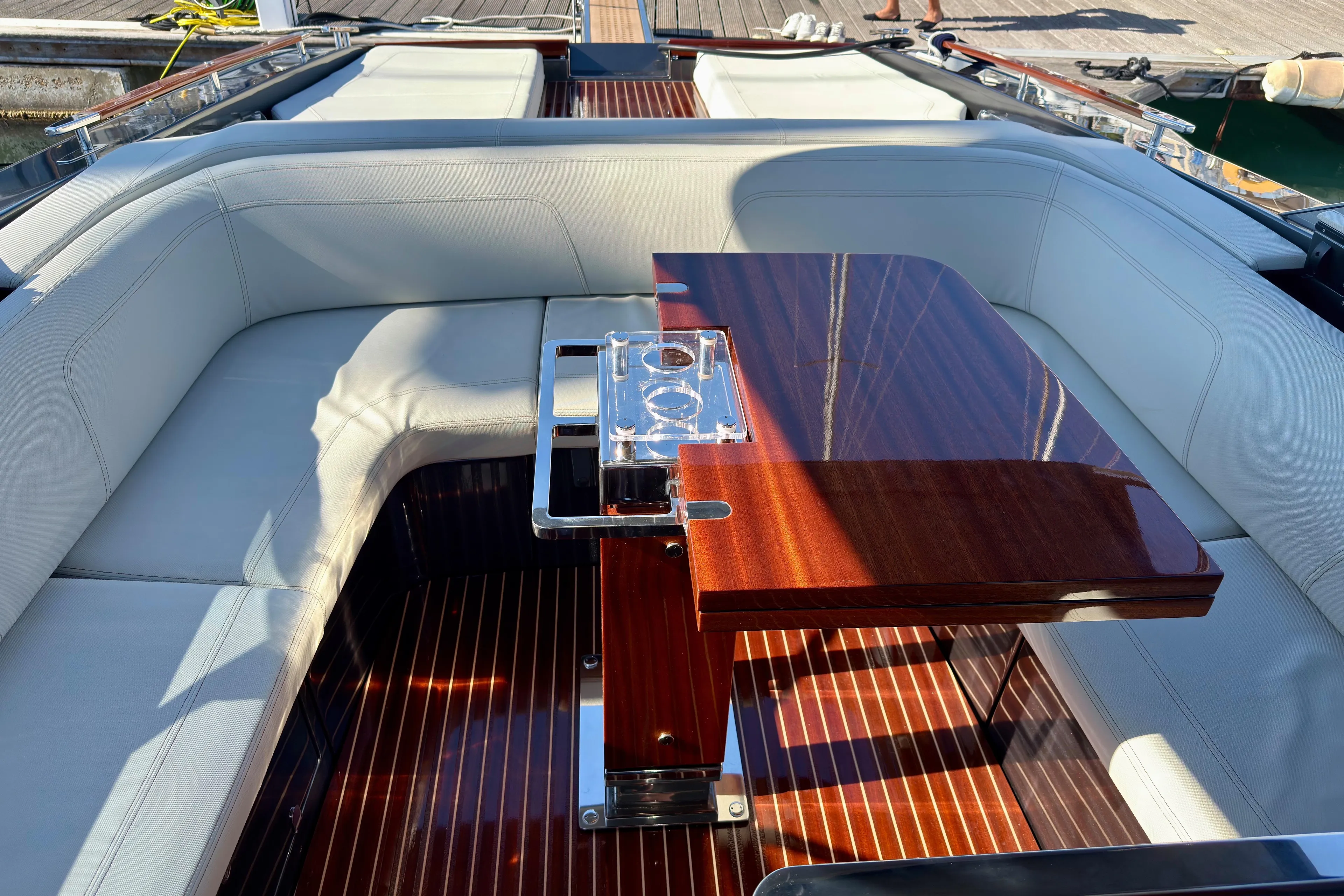  Yacht Photos Pics Luxurious 2025 Riva Rivamare yacht interior with elegant seating and polished wooden table.