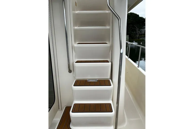  Yacht Photos Pics Staircase on 2006 Mainship 34 Trawler with teak steps and stainless steel handrail.