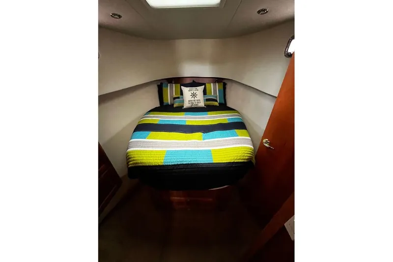  Yacht Photos Pics Cozy cabin bedroom in 2006 Mainship 34 Trawler with colorful bedding.