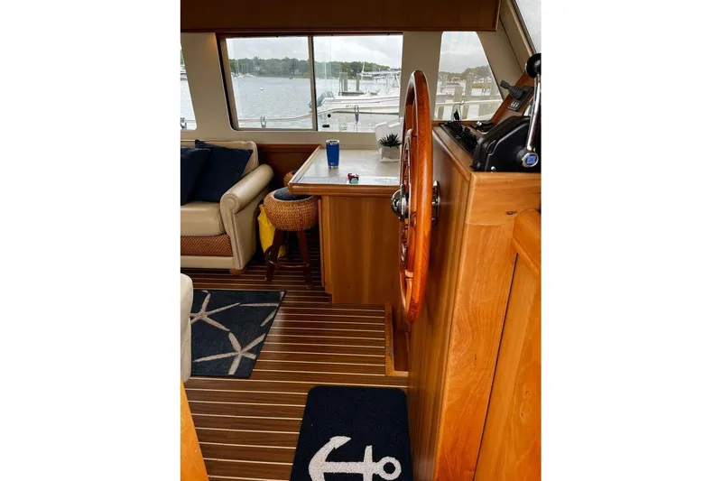  Yacht Photos Pics Interior of 2006 Mainship 34 Trawler with wooden helm and nautical decor.