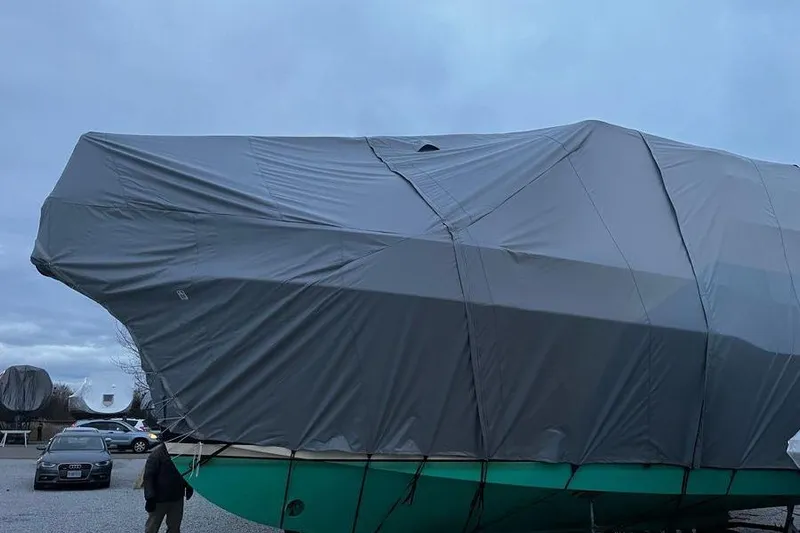  Yacht Photos Pics Covered 2006 Mainship 34 Trawler in storage, with protective tarp, overcast sky.
