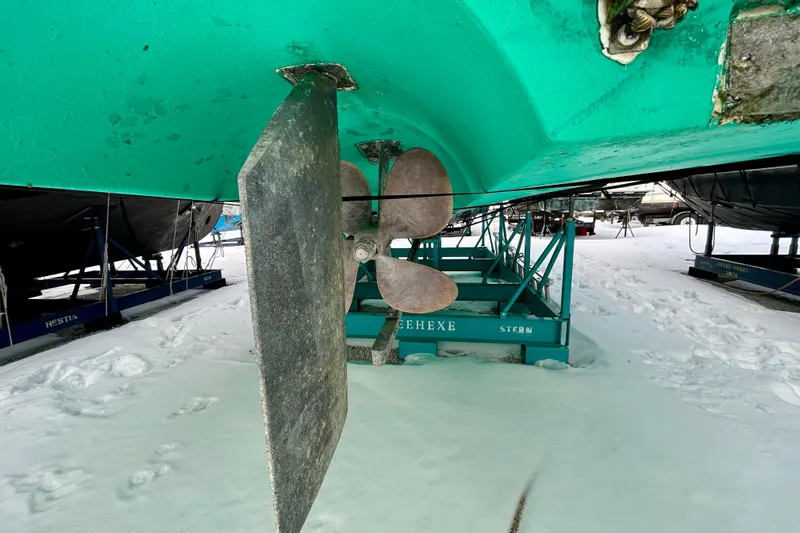  Yacht Photos Pics 2006 Mainship 34 Trawler propeller and rudder on snowy boatyard stand.