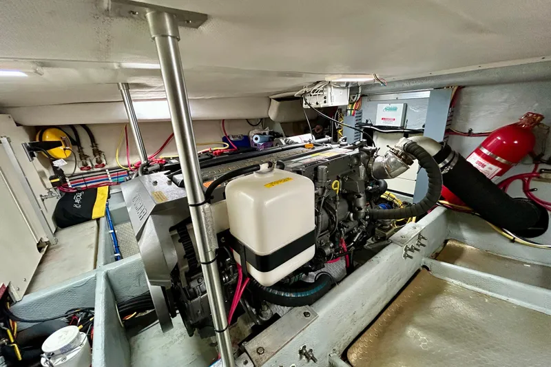  Yacht Photos Pics Engine room of 2006 Mainship 34 Trawler with visible machinery and fire extinguisher.