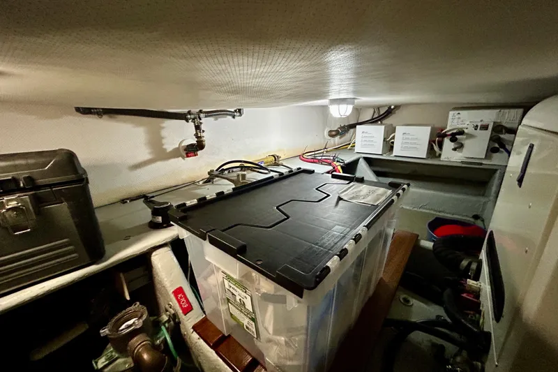  Yacht Photos Pics Engine room of a 2006 Mainship 34 Trawler with storage and equipment.