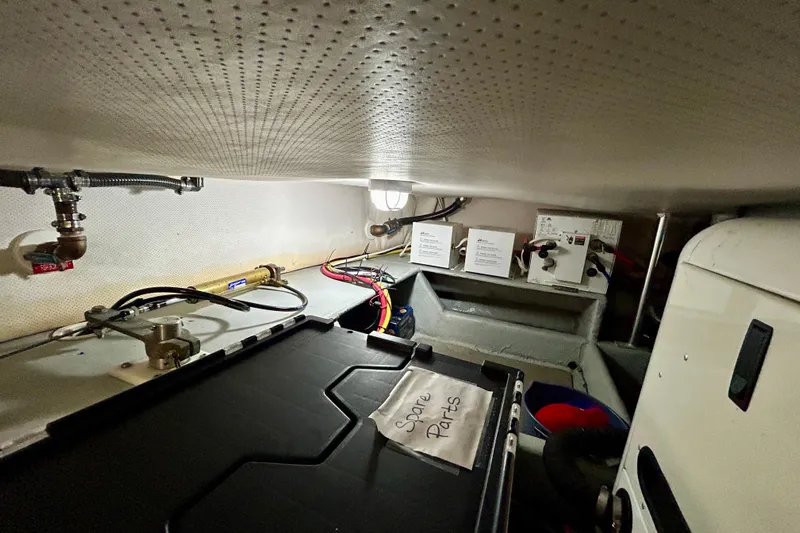  Yacht Photos Pics Engine room of 2006 Mainship 34 Trawler with spare parts and wiring.