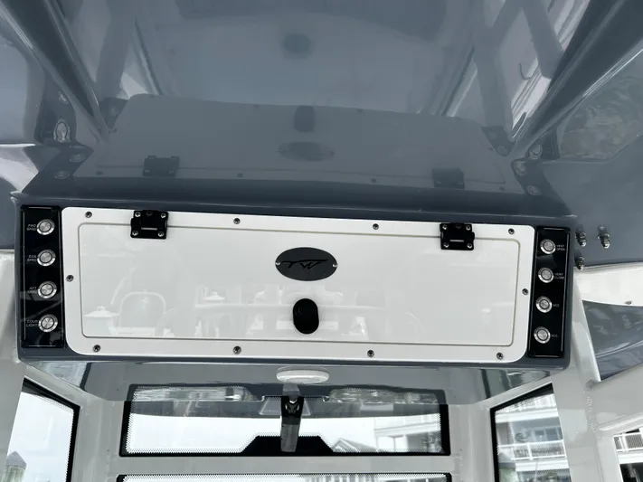  Yacht Photos Pics 2024 Tidewater 280 CC Adventure boat console with storage compartment and sleek design.