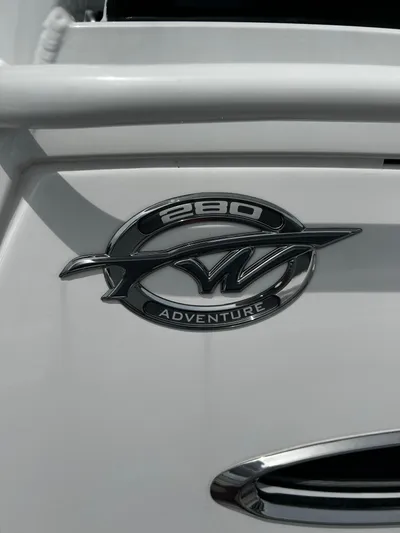  Yacht Photos Pics 2024 Tidewater 280 CC Adventure boat emblem on white surface.