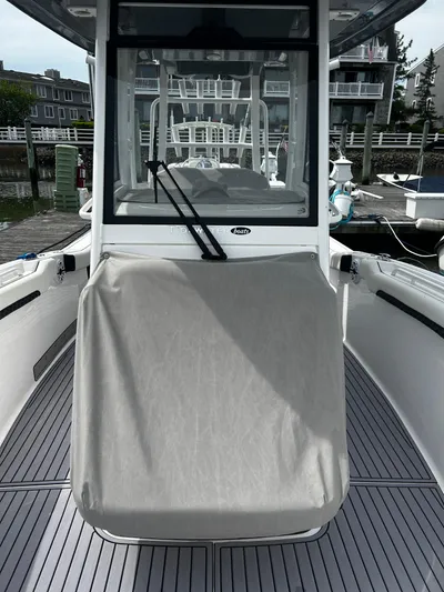  Yacht Photos Pics 2024 Tidewater 280 CC Adventure boat docked, featuring sleek design and covered console.
