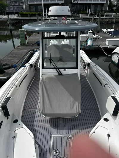  Yacht Photos Pics 2024 Tidewater 280 CC Adventure boat docked, showcasing sleek design and spacious deck.