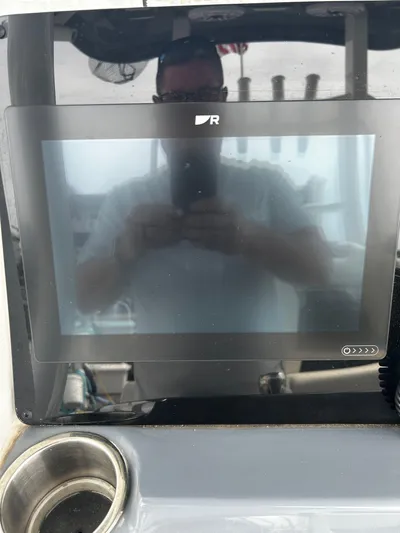  Yacht Photos Pics 2024 Tidewater 280 CC Adventure boat dashboard with touchscreen display.