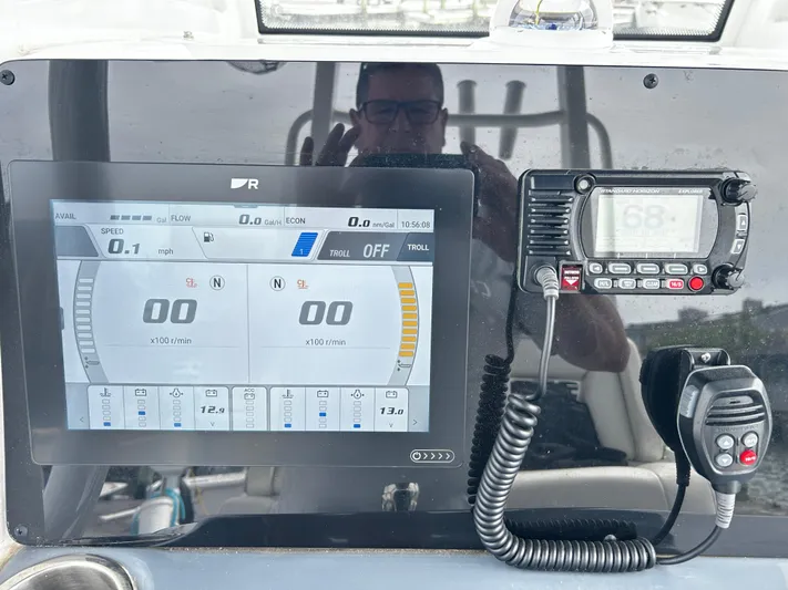  Yacht Photos Pics 2024 Tidewater 280 CC Adventure dashboard with digital display and marine radio.