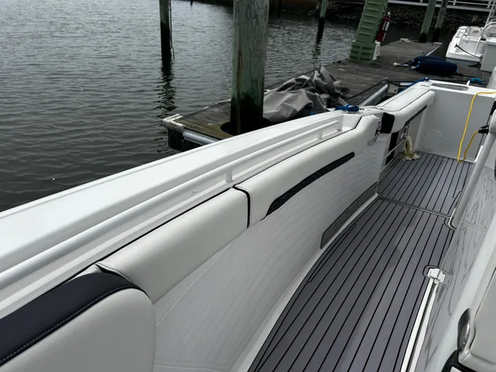  Yacht Photos Pics 2024 Tidewater 280 CC Adventure boat with sleek seating and dockside view.