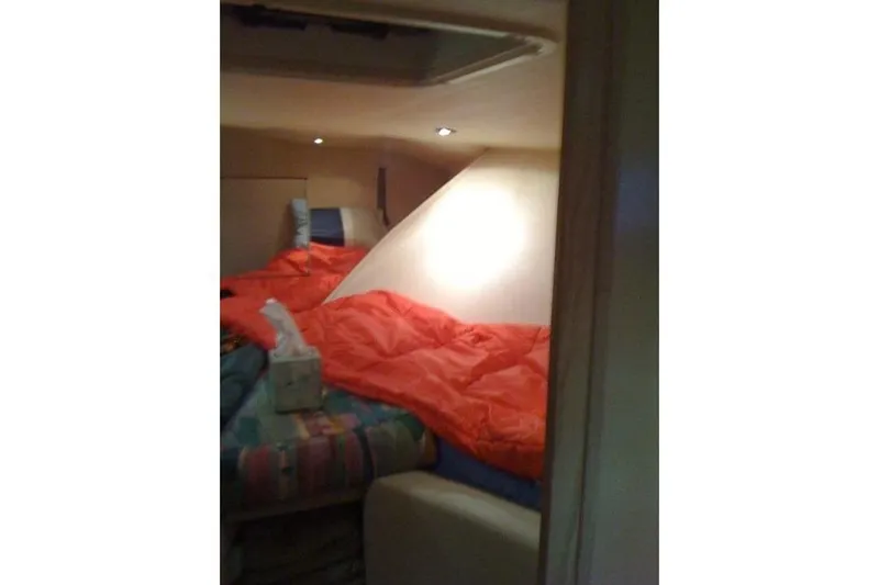  Yacht Photos Pics Cozy cabin interior of 1995 Hatteras 39 Sport Express with red bedding.