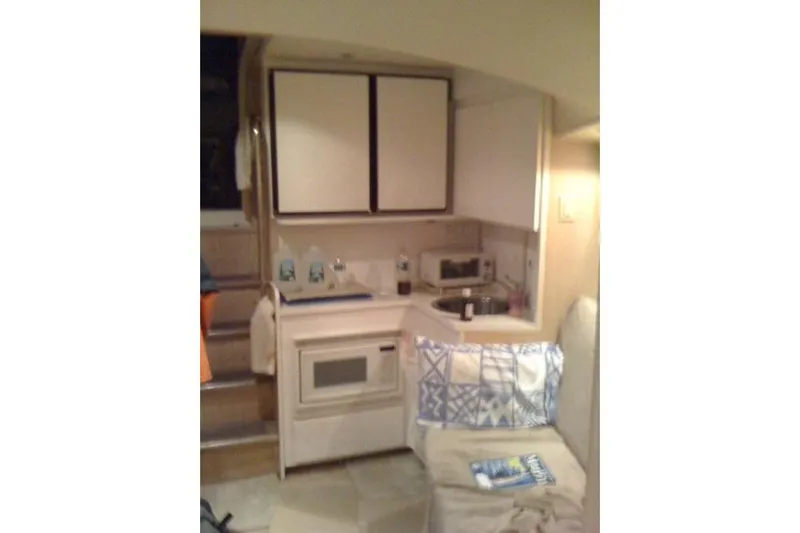  Yacht Photos Pics Interior of 1995 Hatteras 39 Sport Express yacht with kitchenette and seating area.