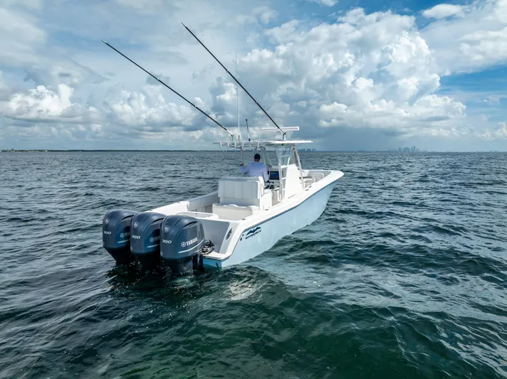  Yacht Photos Pics 2018 Invincible 36 boat with triple outboard engines on open water.