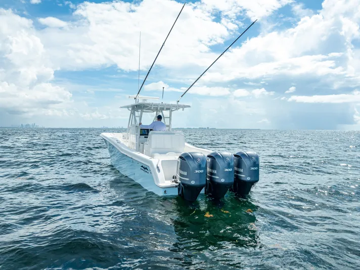  Yacht Photos Pics 2018 Invincible 36 boat with triple outboard engines on open water.