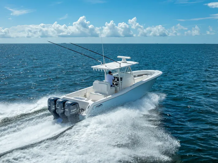  Yacht Photos Pics 2018 Invincible 36 boat cruising on open water with triple outboard engines.