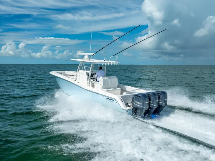  Yacht Photos Pics 2018 Invincible 36 boat speeding on open water with triple Yamaha engines.