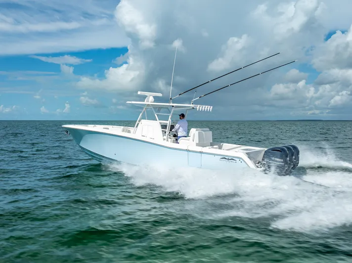  Yacht Photos Pics 2018 Invincible 36 boat cruising on open water under a partly cloudy sky.