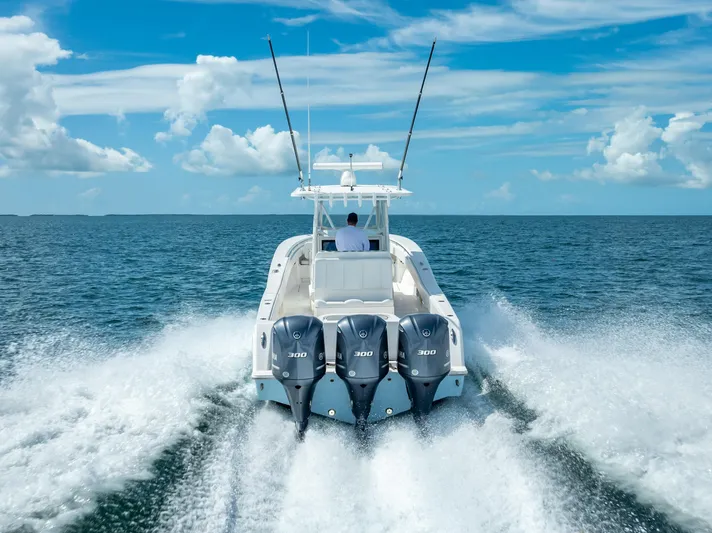  Yacht Photos Pics 2018 Invincible 36 boat with triple outboard engines cruising on open water.