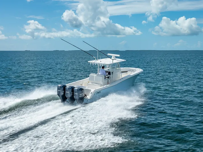  Yacht Photos Pics 2018 Invincible 36 boat cruising on open water with triple outboard engines.