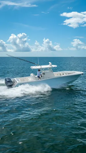  Yacht Photos Pics 2018 Invincible 36 boat cruising on open water under a clear blue sky.