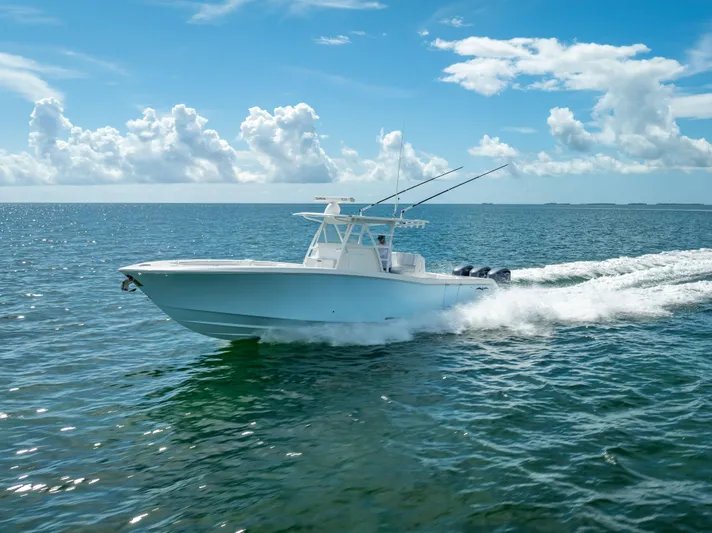  Yacht Photos Pics 2018 Invincible 36 boat cruising on open water under a clear sky.