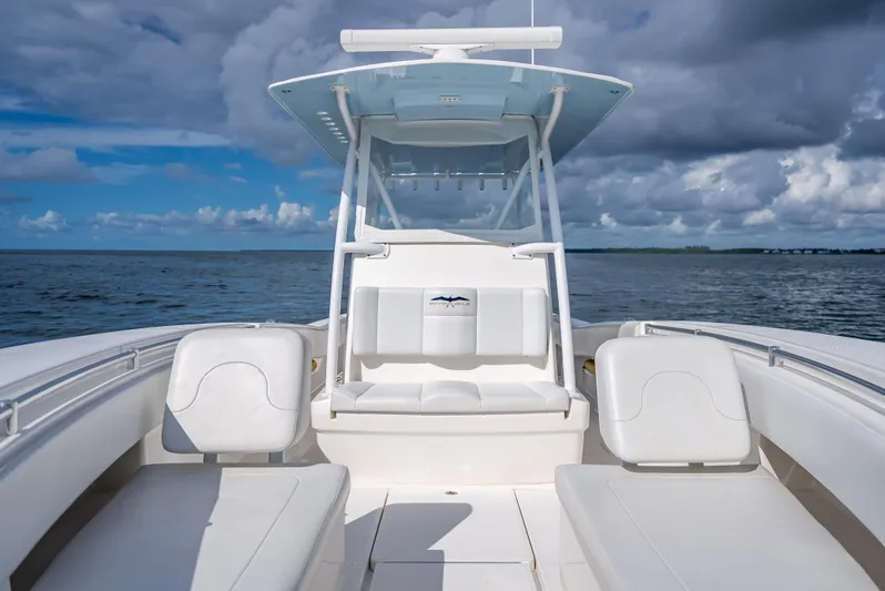  Yacht Photos Pics 2018 Invincible 36 boat interior with white seating and ocean backdrop.