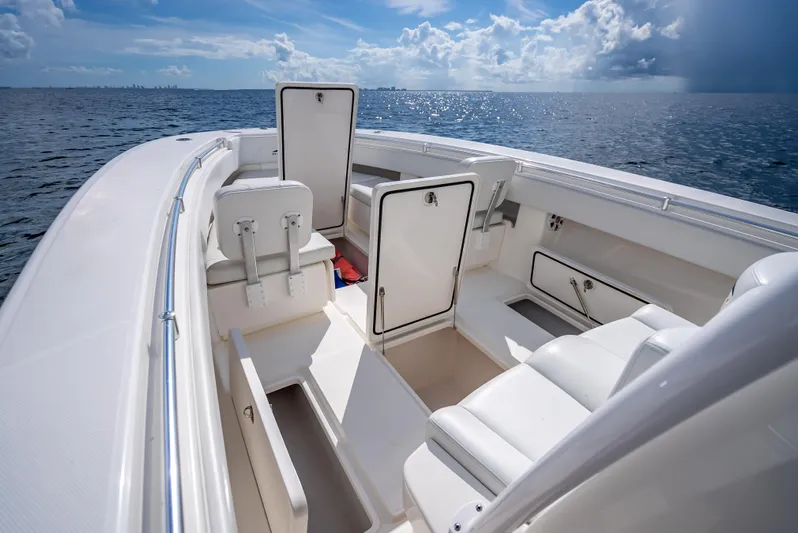  Yacht Photos Pics 2018 Invincible 36 boat interior with open storage compartments on a sunny day.