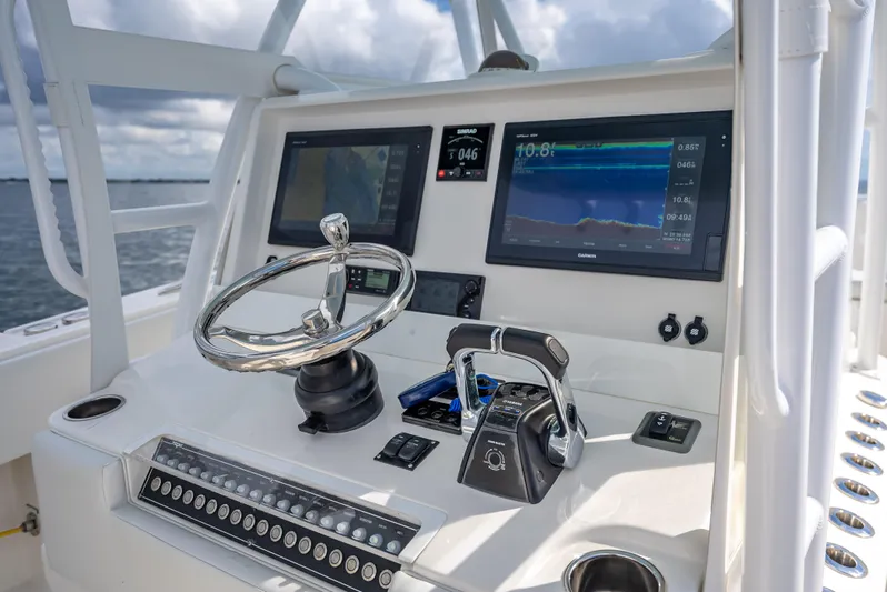  Yacht Photos Pics 2018 Invincible 36 boat dashboard with steering wheel, navigation screens, and controls.