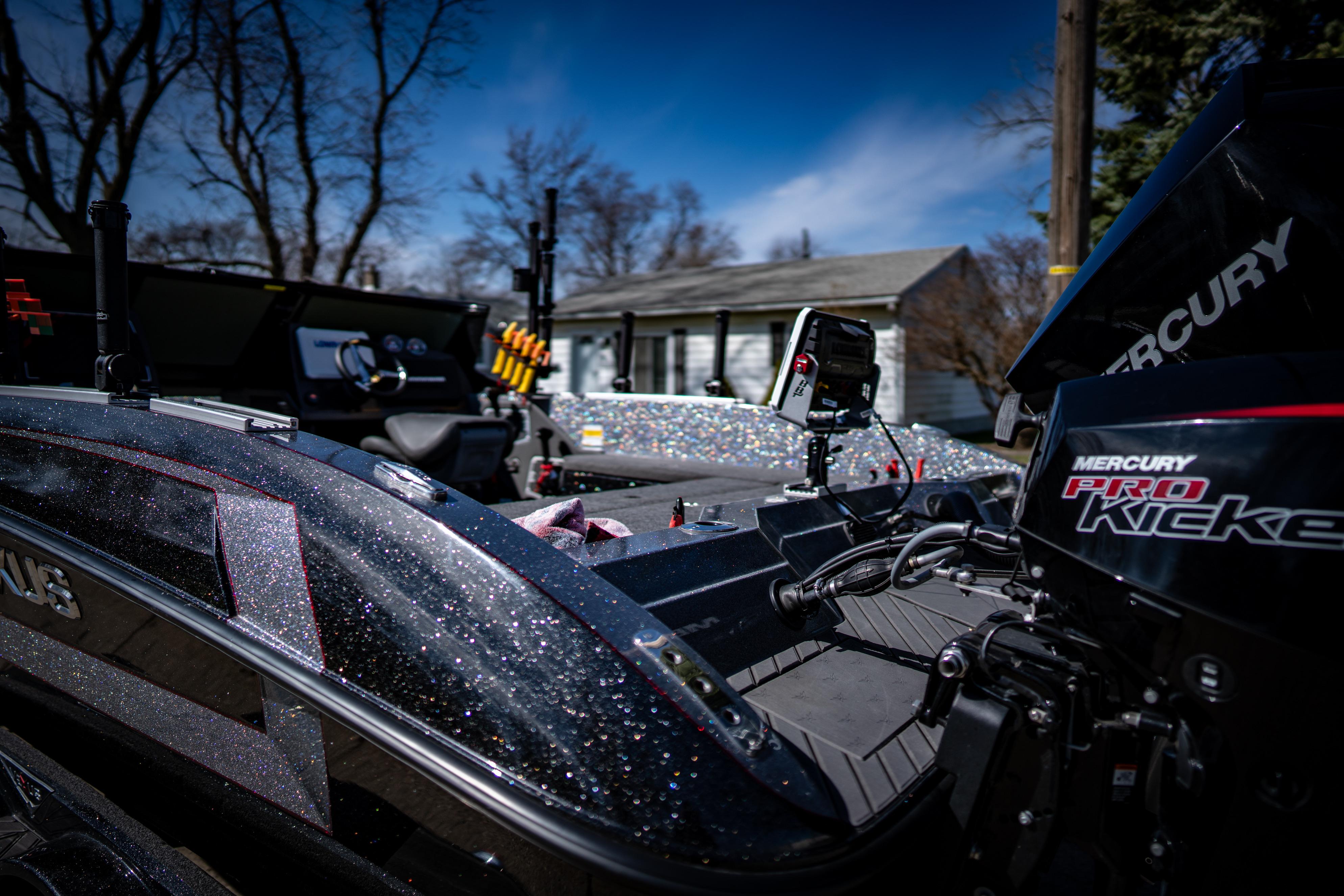 2022 Vexus DVX20 boat with Mercury Pro Kicker engine in a residential area.