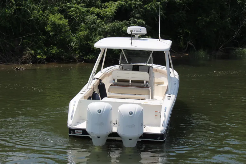  Yacht Photos Pics 2016 Pursuit S 280 Sport boat with dual engines on a calm river.