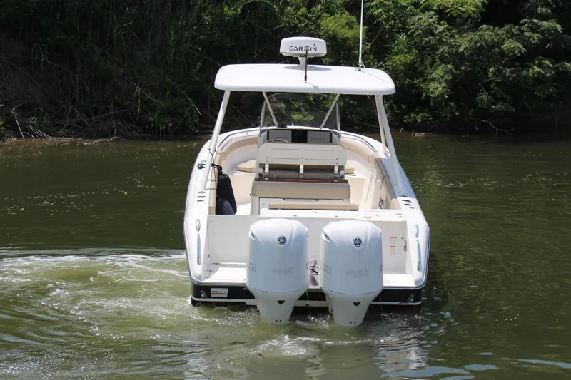  Yacht Photos Pics 2016 Pursuit S 280 Sport boat with dual engines on a calm river.