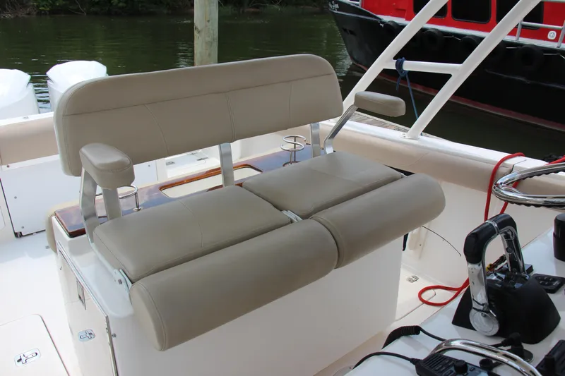  Yacht Photos Pics 2016 Pursuit S 280 Sport boat interior with beige seating and control panel.