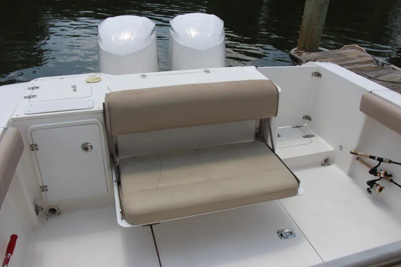  Yacht Photos Pics 2016 Pursuit S 280 Sport boat with beige seating and dual engines at dock.