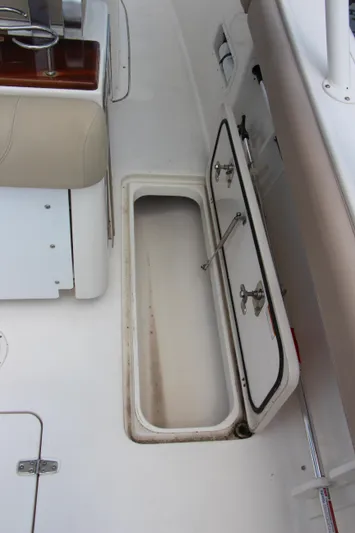  Yacht Photos Pics 2016 Pursuit S 280 Sport boat storage compartment with open hatch.