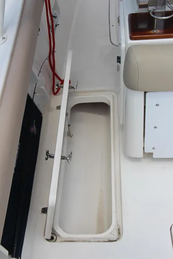  Yacht Photos Pics 2016 Pursuit S 280 Sport boat storage compartment with open hatch.