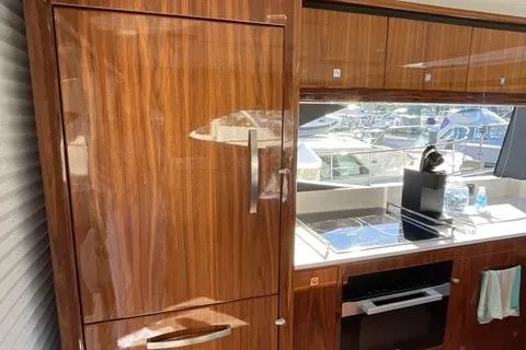  Yacht Photos Pics Luxurious interior of 2025 Riviera 585 SUV yacht with sleek wooden cabinetry.