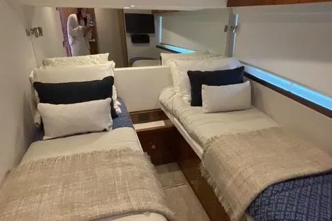  Yacht Photos Pics Interior of 2025 Riviera 585 SUV yacht with twin beds and modern decor.