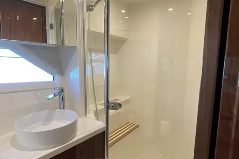  Yacht Photos Pics Luxurious bathroom in 2025 Riviera 585 SUV yacht with modern fixtures and elegant design.